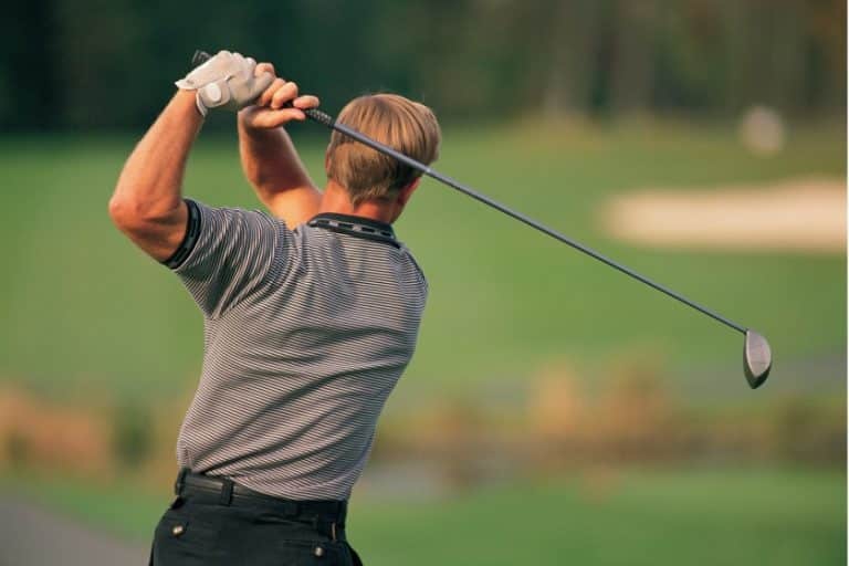 A man plays golf