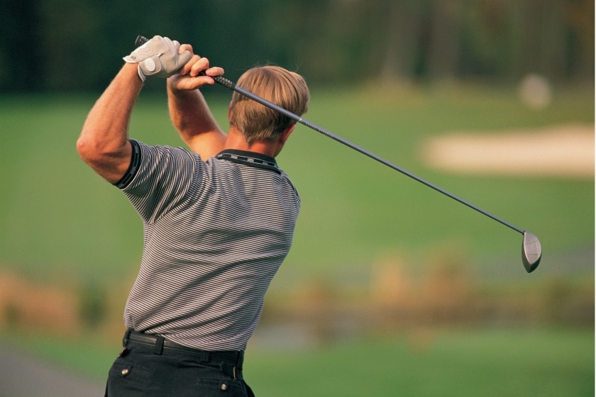 A man plays golf